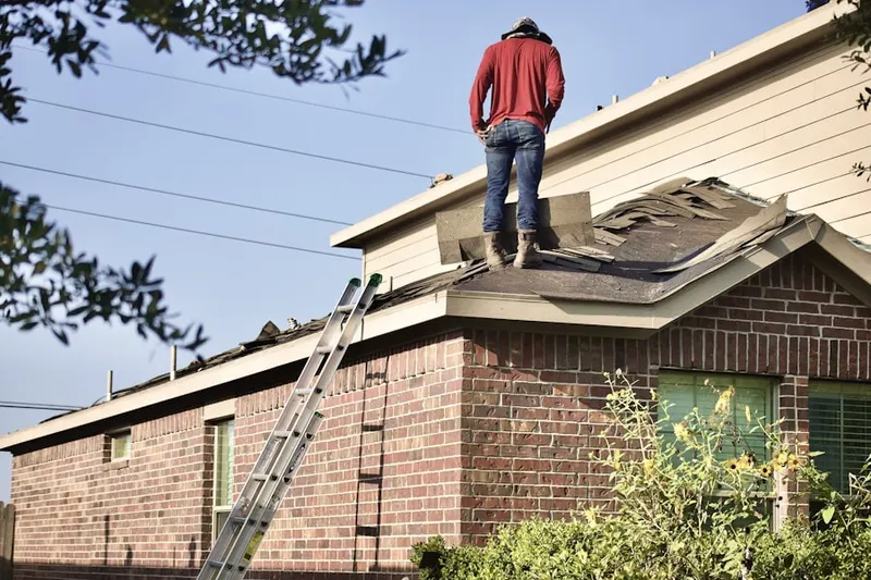 Professional roofer working on a residential roof in Shenango